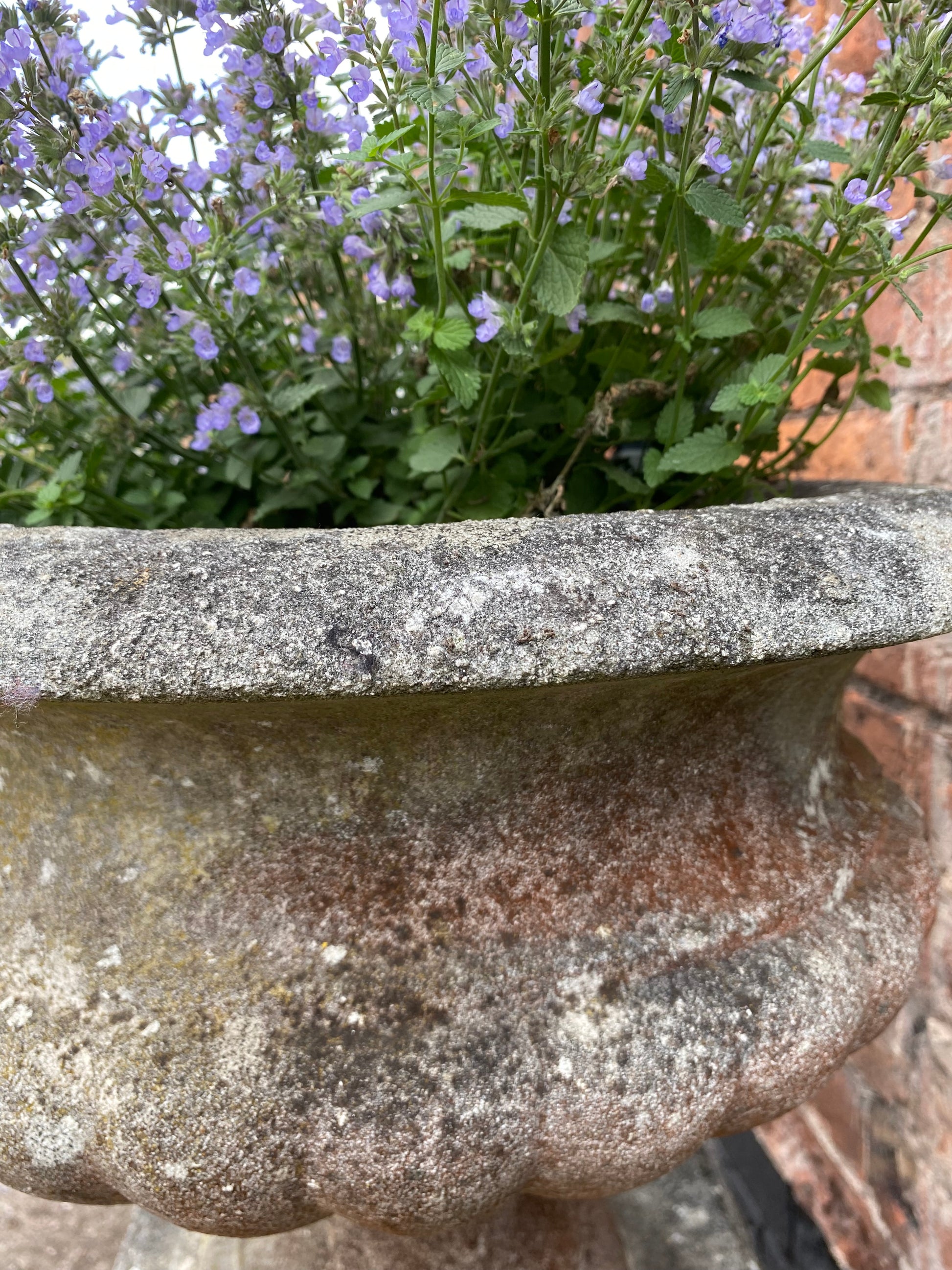 Close up of weathered surface of decorative stone urn