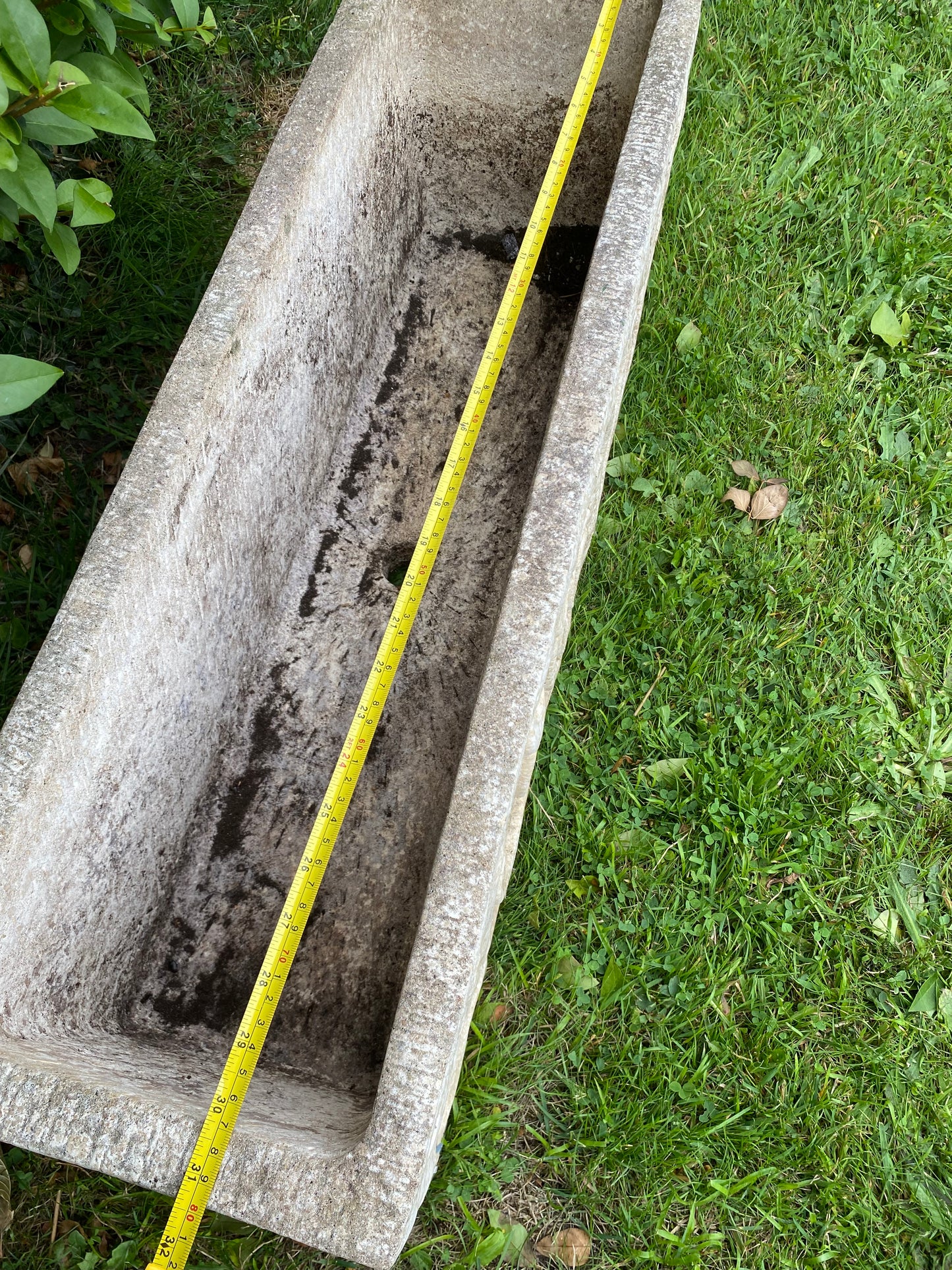 Composite stone planter with measuring tape for scale